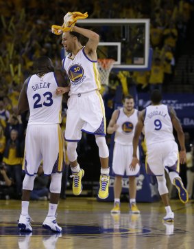 On top: Steph Curry celebrates with Draymond Green during a timeout as the Warriors rolled to an easy win.