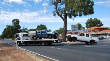 Vehicles linked to the roof-fixing scam are removed from Hazelmere's Banksia Tourist Park.