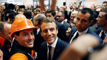 President Emmanuel Macron poses with workers before meeting construction businessmen in Paris in October.