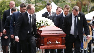 Final farewell: Brother Jason, left, and father Greg, right, carry Phillip Hughes' coffin during the funeral service.