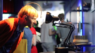 Neil Harbisson, the world's first cyborg, with Pinokio, the curious robotic desk lamp that wants to capture your attention.