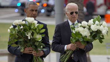President Barack Obama and Vice-President Joe Biden carry bouquets of 49 white roses in total, at a memorial to the 49 victims of the Pulse nightclub shooting.