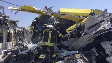 Italian firefighters search among debris at the scene of the train accident.