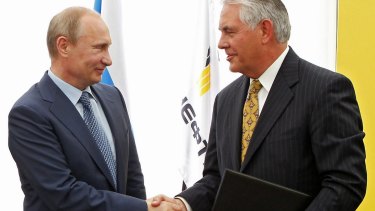 Mr Putin, left, and ExxonMobil chief executive Rex Tillerson.
