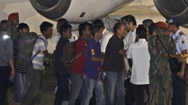 Kidnapped Indonesians crewmen in the Philippines are greeted by officials upon arrival at Halim Perdanakusuma Airbase in Jakarta on Sunday.