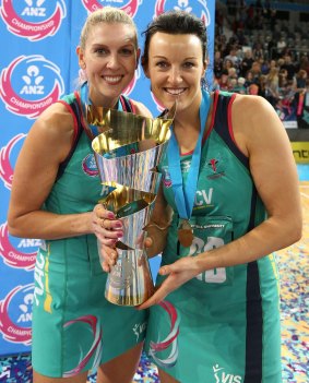 Cath Cox (left) and Bianca Chatfield hold the trophy following victory in the 2014 ANZ Championship grand final.