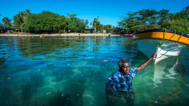Jackson Kiloe, the Premier of Taro in the Solomon Islands, standing where the shoreline used to be. 
