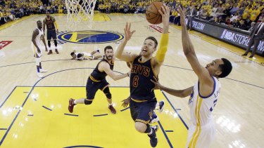 Matthew Dellavedova drives to the basket past Golden State Warriors' Shaun Livingston in game 1 of the NBA finals in June.