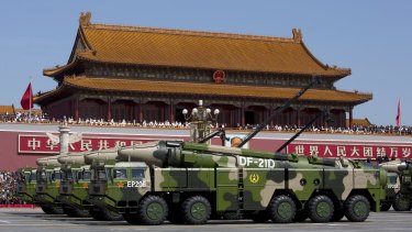 Chinese military vehicles carrying DF-21D anti-ship ballistic missiles, potentially capable of sinking a US Nimitz-class aircraft carrier in a single strike, drive past Tiananmen Gate on Thursday.