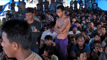 Former fishing slaves gather at their temporary shelter in Tual, Indonesia. 