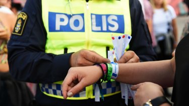 Continued issue with a police officer attaching a bracelet with the text #tafsainte, meaning don't grope, to a visitor's wrist at the Bravalla Festival in Norrkoping, Sweden, in 2016 after reports of five rapes and more than a dozen suspected sexual assaults.