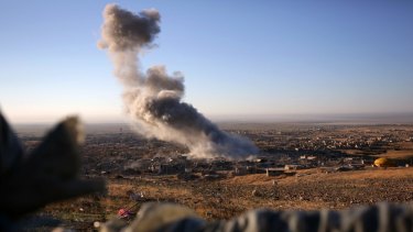 Smoke believed to be from an airstrike billows over Sinjar on Thursday.