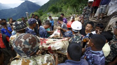 Rescue team members from the Nepalese Army retrieve the body of a landslide victim at Lumle village near the Annapurna Circuit.
