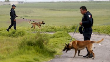 Policemen patrol with dogs near Altiplano Federal Penitentiary on Tuesday.
