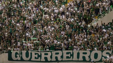 Supporters of Brazil's Chapecoense gather for a memorial for the players who died in a plane crash in Colombia, at Arena Condado stadium in Chapeco, Brazil, on November 30. The banner reads "warriors".