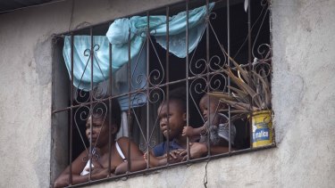 Haitians watch the protests. The country is the poorest in the Western Hemisphere.