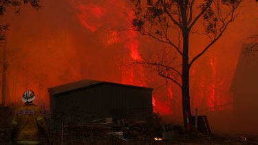 Bushfires close in on a home near Dargan in the Blue Mountains in 2013.
