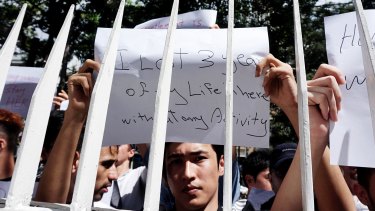 Dozens of asylum seekers hold posters during protest in front of the UNHCR office in Jakarta on Monday.