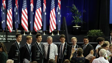 Industry Minister Ian Macfarlane poses for photos with students ahead of US President Barack Obama's speech at the University of Queensland.