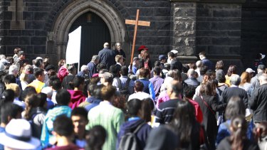 Crowds gather for the Way of the Cross procession in Melbourne.