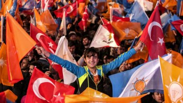 Supporters wave flags outside the ruling AK Party headquarters in Ankara on Sunday. 