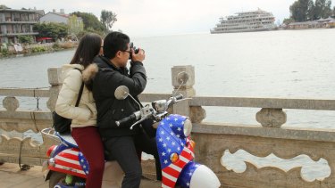 A young Chinese couple take a photo in Dali, a city of 1 million that saw 24 million people visit last year.