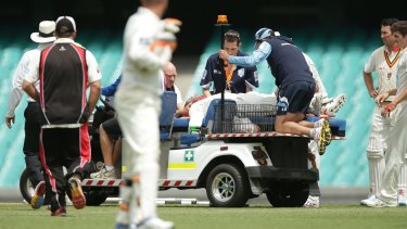 NSW team doctor John Orchard works on Phillip Hughes at the SCG. 