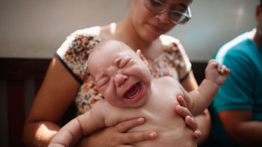 David Henrique Ferreira, 5 months, who was born with microcephaly, is held by his mother in Recife, Brazil.