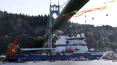 The Royal Dutch Shell PLC icebreaker Fennica heads up the Willamette River under protesters hanging from the St Johns Bridge on its way to Alaska.