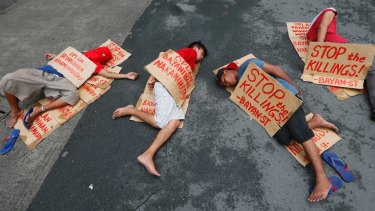 People stage a "die-in" to protest the rising number of extra judicial killings related to Philippine President Rodrigo Duterte's "War on Drugs".