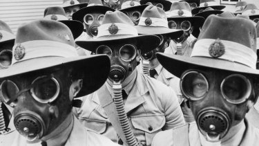 Australian soldiers sport gas masks in World War II.
