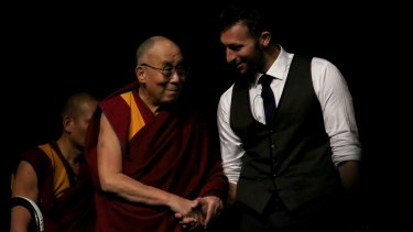 Former Olympic swimmer Ian Thrope introduces His Holiness the 14th Dalai Lama during a teaching visit at the Brisbane Convention and Exhibition Centre.