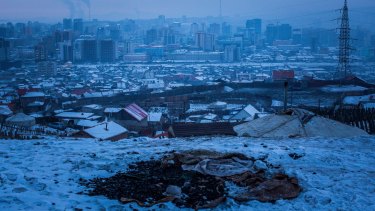 A pile of coal exposed in the snow on an abandoned lot in Ulaanbaatar, Mongolia. The burning of raw coal in the city will be banned from April 2019.