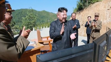 North Korea leader Kim Jong Un, centre, applauds after the launch of an intercontinental ballistic missile last month.