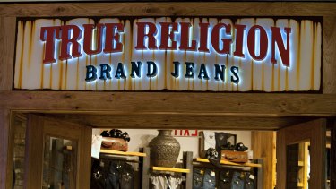 True Religion Apparel Inc. signage is displayed outside of a store at the Beverly Center mall in Los Angeles, California, US, on Monday, December 5, 2011.