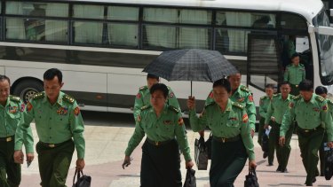 Appointed lawmakers who represent Myanmar's military arrive for a parliamentary session in Naypyitaw on Monday.