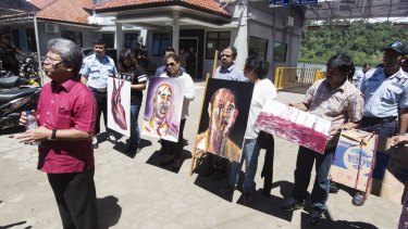 Paintings by Myuran Sukumaran, signed by all nine awaiting execution, are displayed by Sukumaran's family at Wijaya Pura in Cilacap on the day of the execution. 