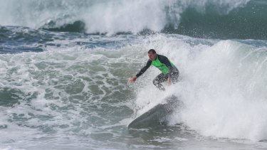 Mr Abbott pictured during a surf competition last year. 
