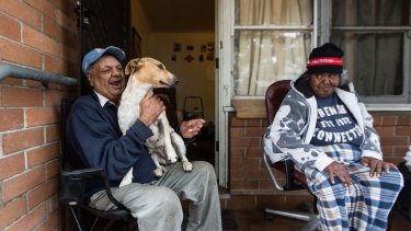 Waterloo public housing resident Walter Murray with Rose Dodson and Mr Murray's dog Scrappydoo. Mr Murray has greeted the plans with suspicion.