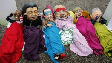 Oxfam activists wear masks of from left, Barack Obama, Xi Jinping, Francois Hollande, India's Prime Minister Narendra Modi, German Chancellor Angela Merkel and Australia's Prime Minister Malcolm Turnbull during the COP21 Conference in Paris this month. The first three are also among the world's top travellers.