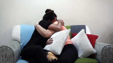 Nicolette Gomes, left, consoles her mother as they hear the news.