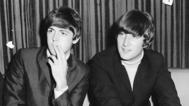 John Lennon (right) with Paul McCartney during a visit to Australia in 1964.