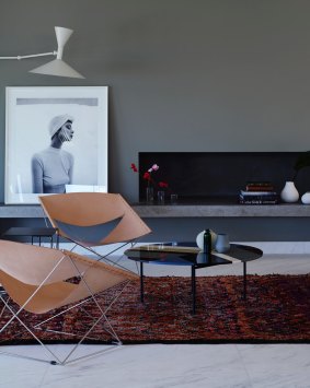 STYLING TIP: Interior design practice Amber Road has used a 10-metre-long concrete bench to link two living areas and styled it with monochromatic art and objects.