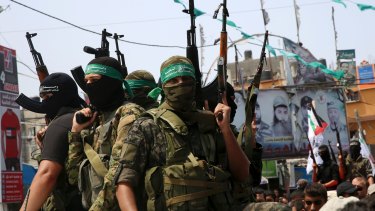 Hamas militants attend the funeral of a border security guard in Rafah refugee camp, Gaza Strip.