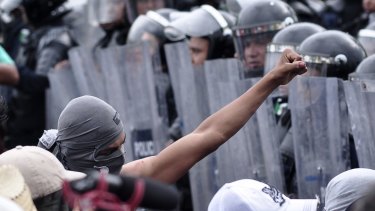 Protestors, some armed with machetes, were confronted by federal police in Acapulco.