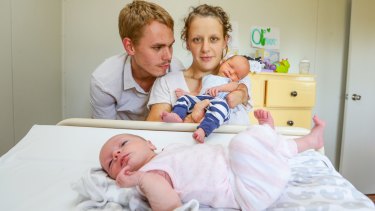 Danielle Weymark with her partner Mathew Johnson and their new born twins, Oliver and Lara. Danielle lost her left arm, right hand and most toes to meningitis as a baby.