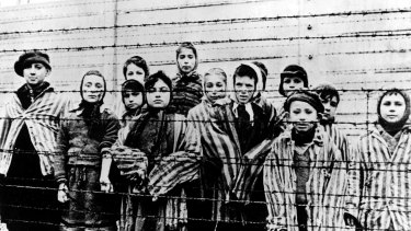 This file photo, taken just after the liberation by the Soviet army in January, 1945, shows a group of children wearing Auschwitz concentration camp uniforms.