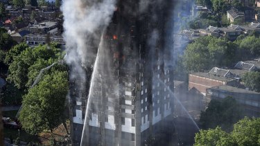 Firefighters tackle the building after a huge fire engulfed the 24-storey Grenfell Tower in Latimer Road, West London. 
