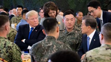 US President Donald Trump, left, and South Korean President Moon Jae-in, right, have lunch with US and South Korean troops at Camp Humphreys in Pyeongtaek, South Korea, on Tuesday.