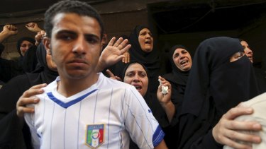 Relatives of 21-year-old Mohamed Adel, an army officer who died during the Sinai clashes, grieve during his funeral. 
